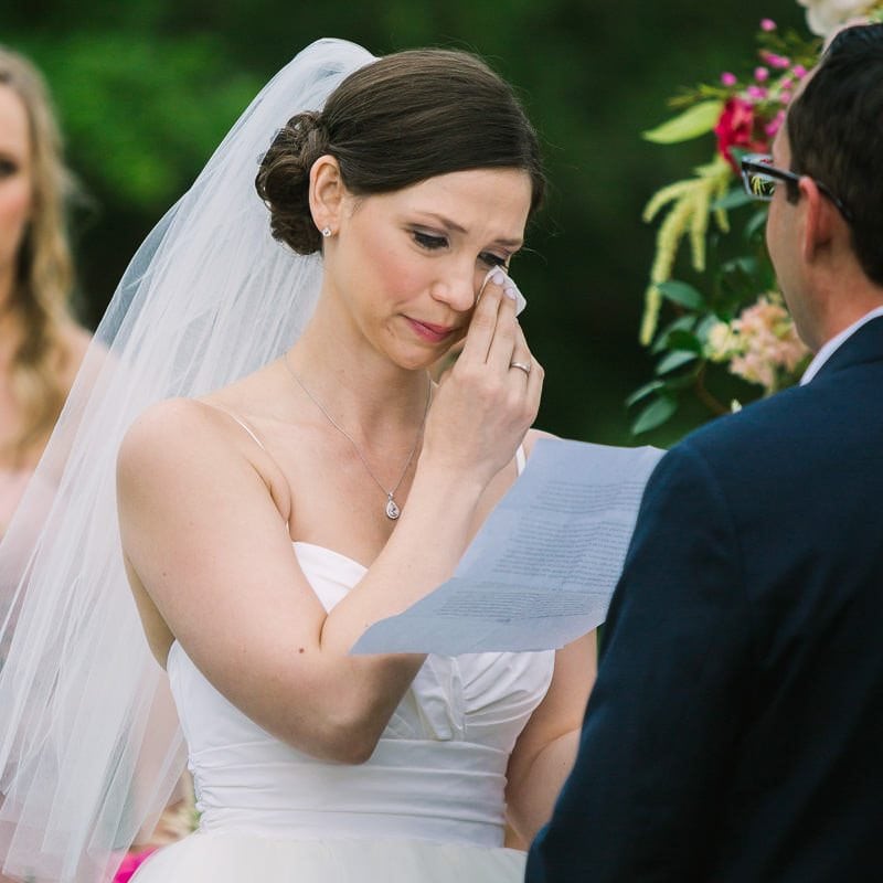 bride cries while she recites her wedding vows