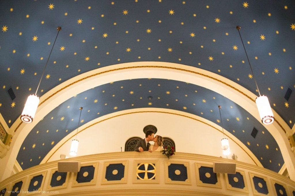 The bride and groom kiss underneath the stars.