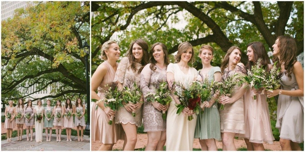 Bridesmaids smile together holding their bouquets at the Julia Ideson Library in Houston, TX.