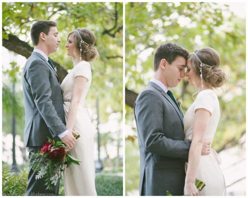 The bride and groom tap foreheads in the courtyard of the Julia Ideson Library.