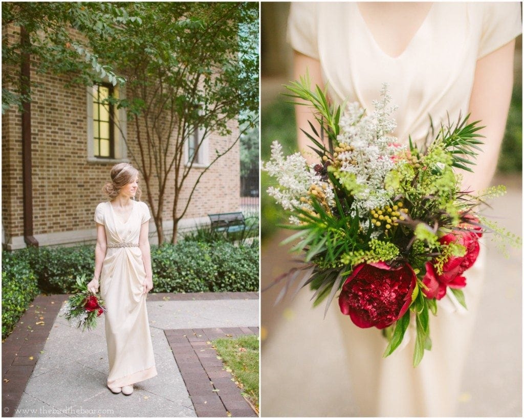The bride holds her deep red bouquet of flowers in her vintage wedding gown before her wedding at the Julia Ideson Library in Houston, TX.
