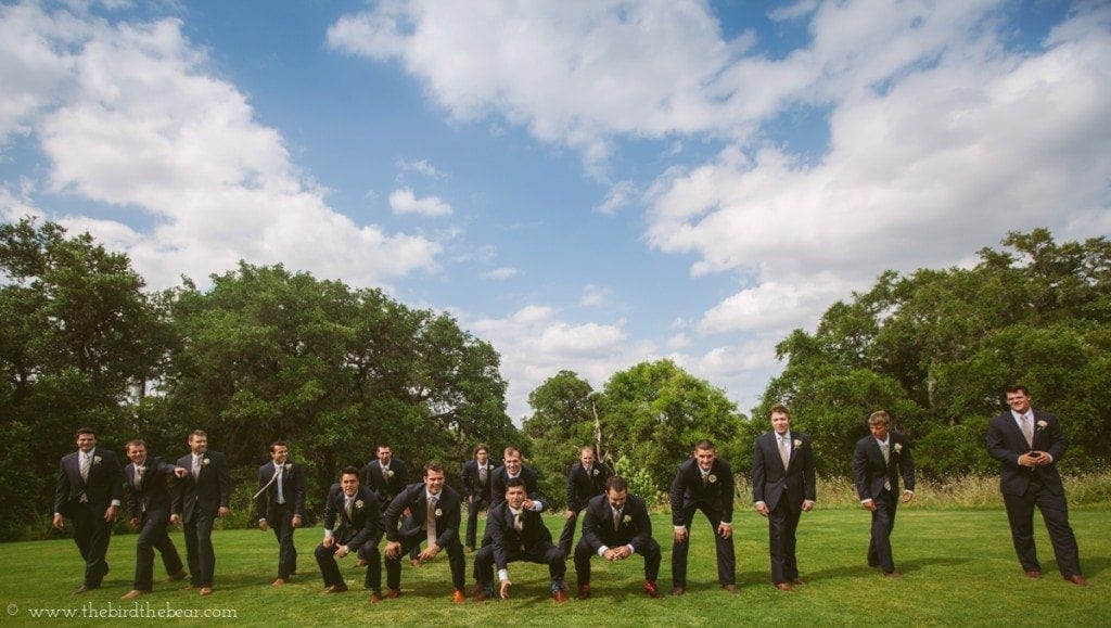 Groom and groomsmen play football before the wedding ceremony.