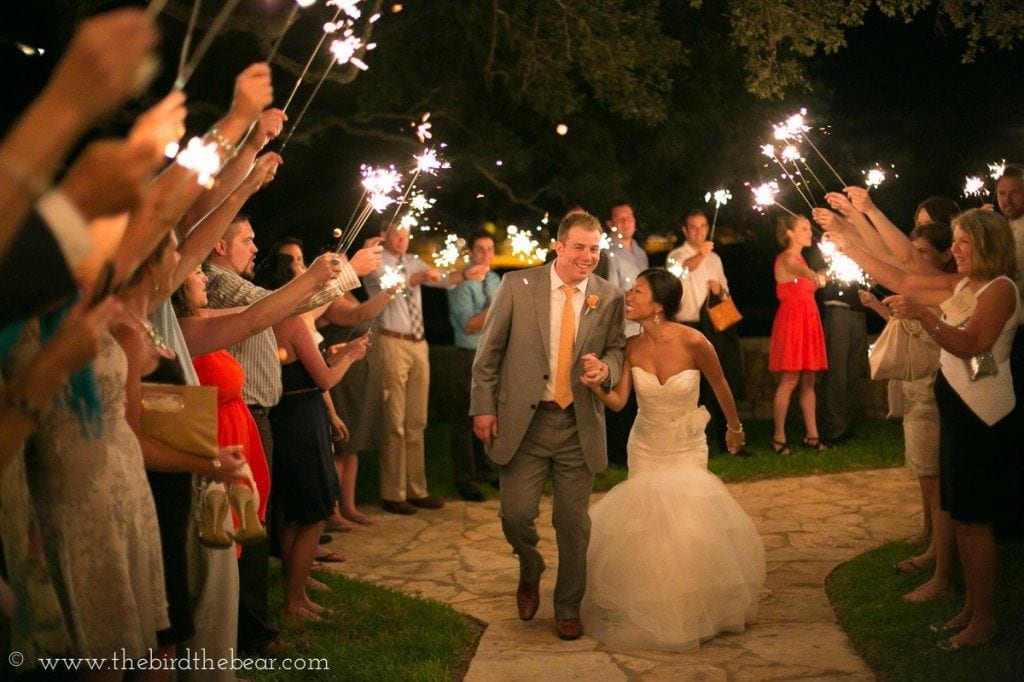 Bride and groom run through sparklers after their wedding at Thurman's Mansion in Driftwood, Texas.