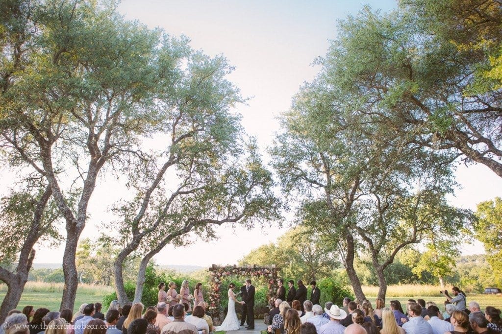 Wedding ceremony under the trees at vista west ranch