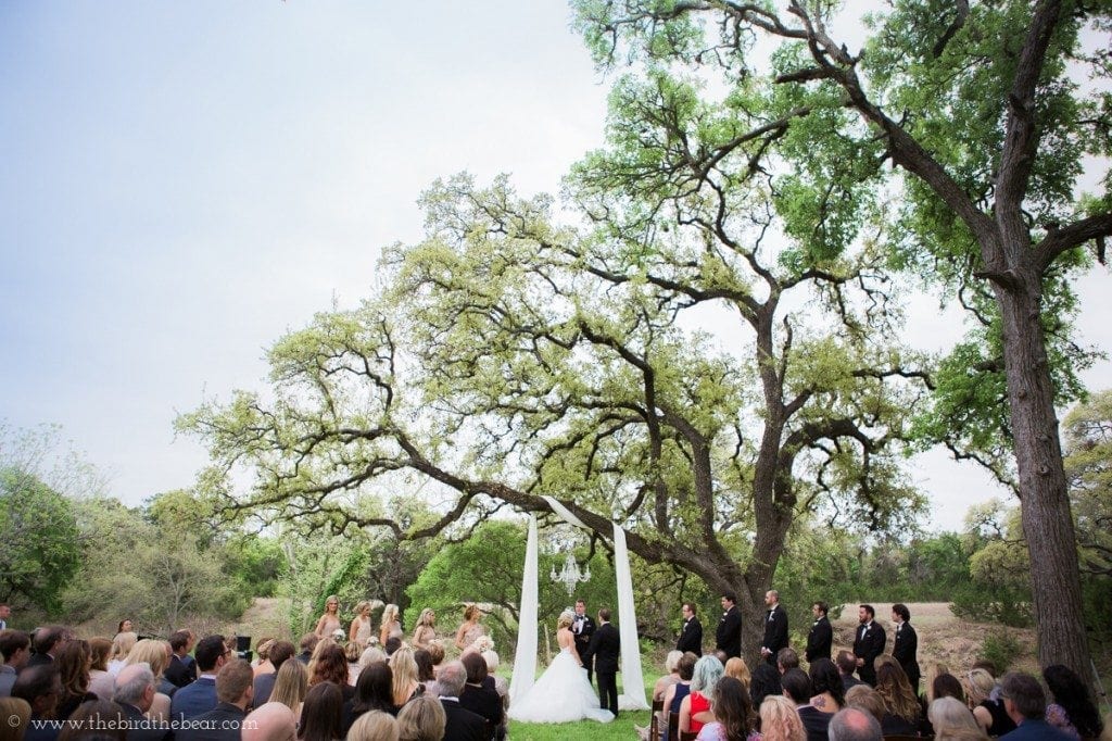 Pecan springs ranch wedding ceremony under the trees in austin, tx