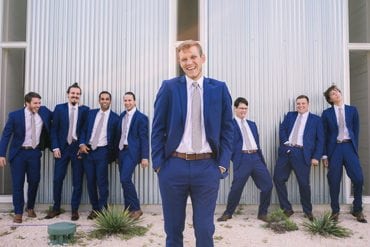 Groomsmen do their best impression of groom while he laughs