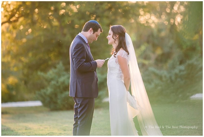 Groom reads a note to his bride while they share a private moment