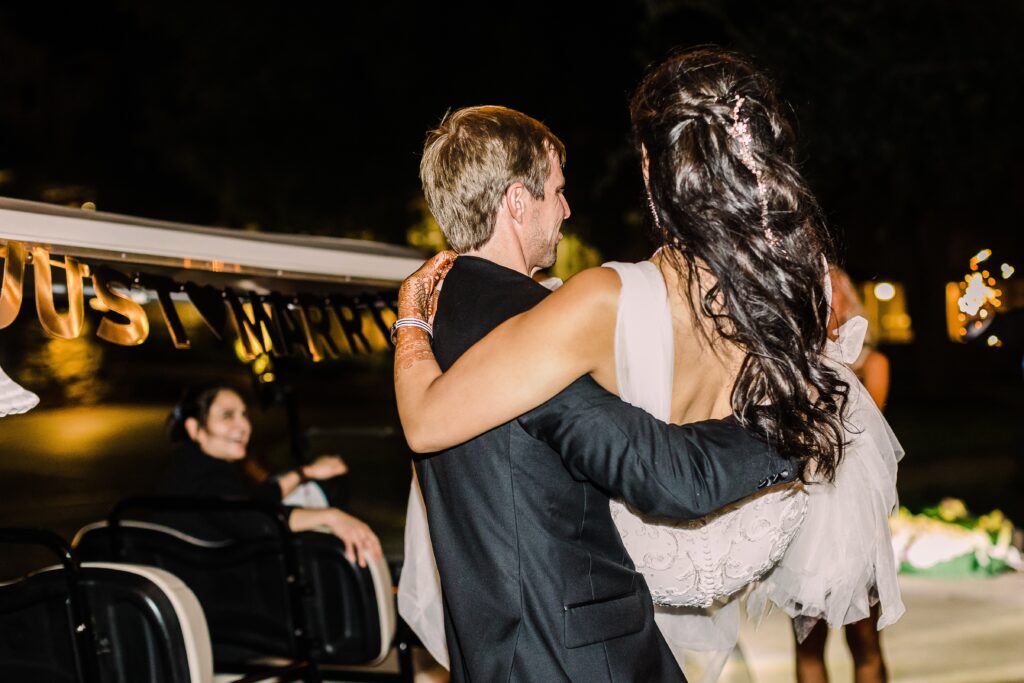 Groom carrying bride to golf cart as part of a Lakeway Resort wedding