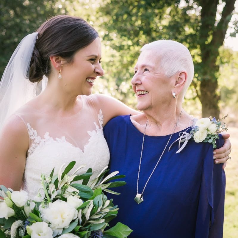 bride and her grandmother smile at each other