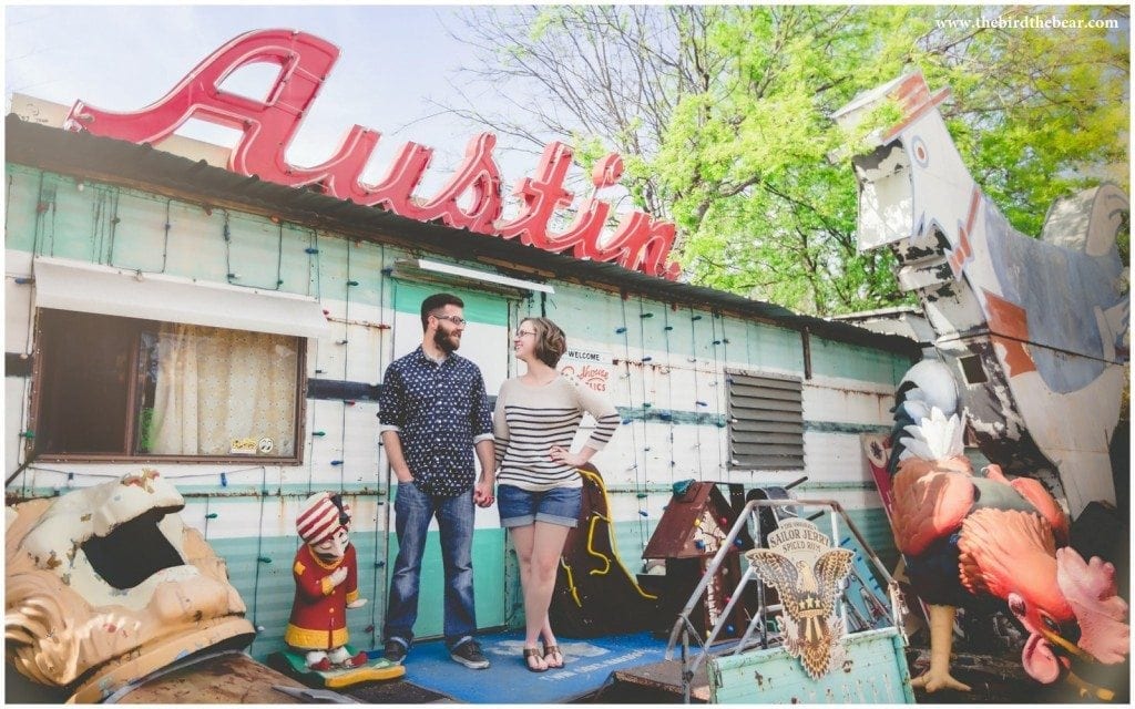 A couple poses in front of the Austin sign at Roadhouse Relics.