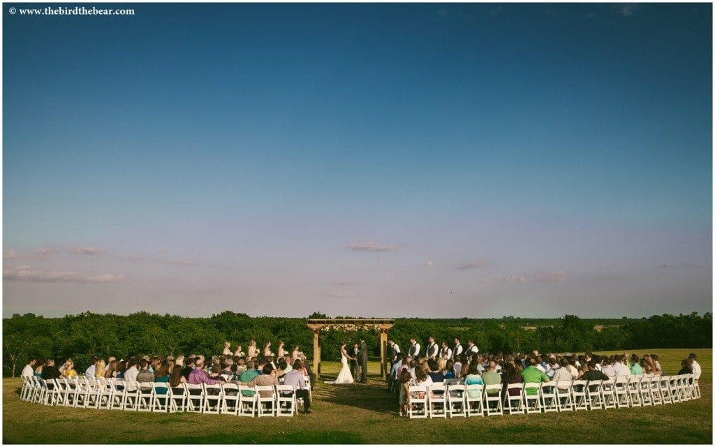 Royalty Pecan Farms wedding ceremony being held at sunset.