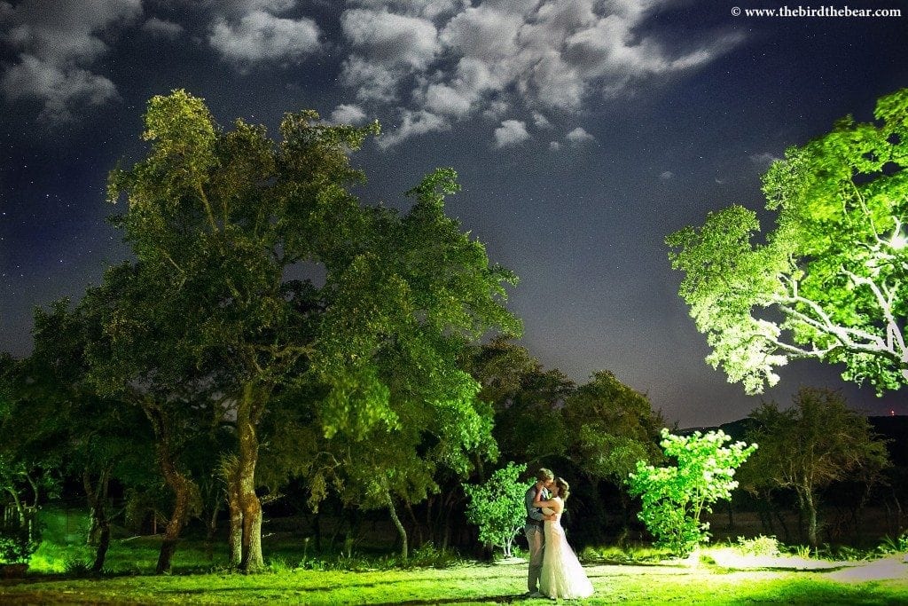 A bride and groom kiss under the stars at their Heritage House wedding in Dripping Springs.