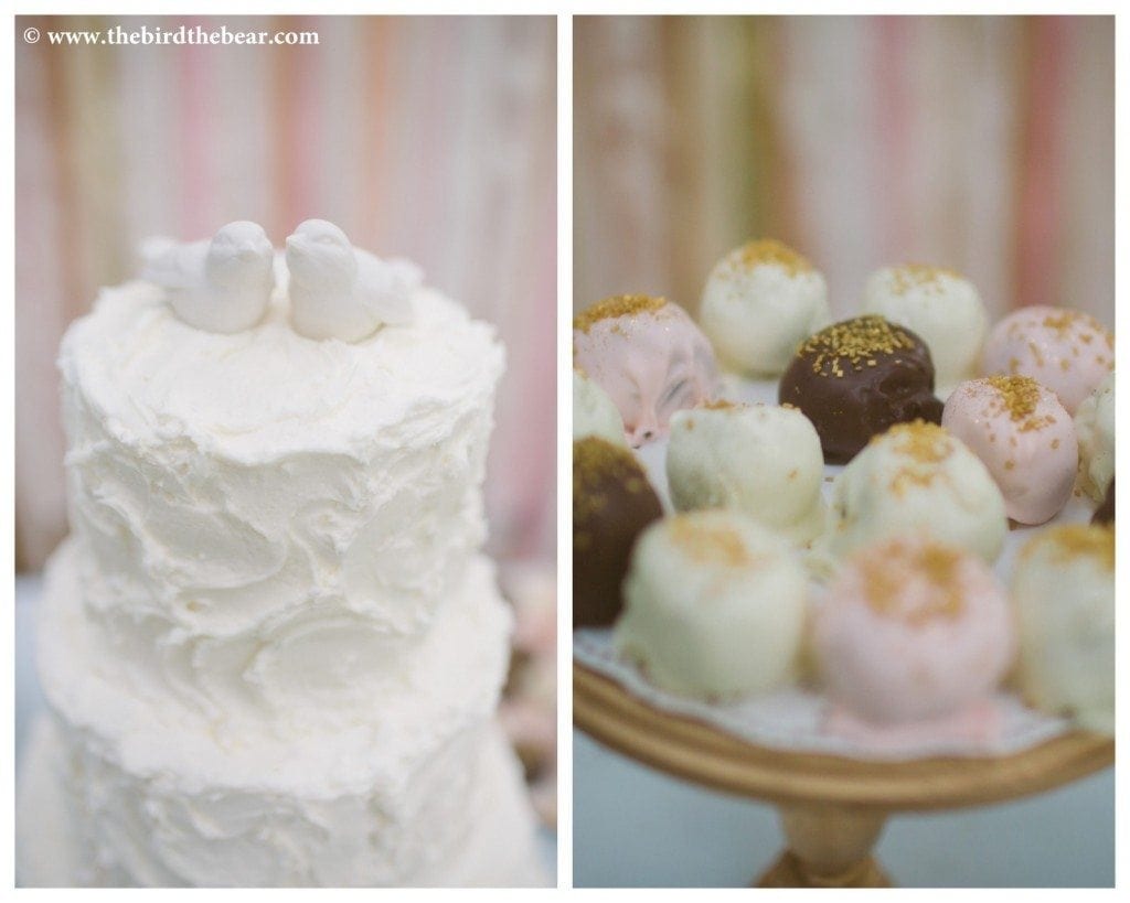 A white wedding cake with white birds on top.