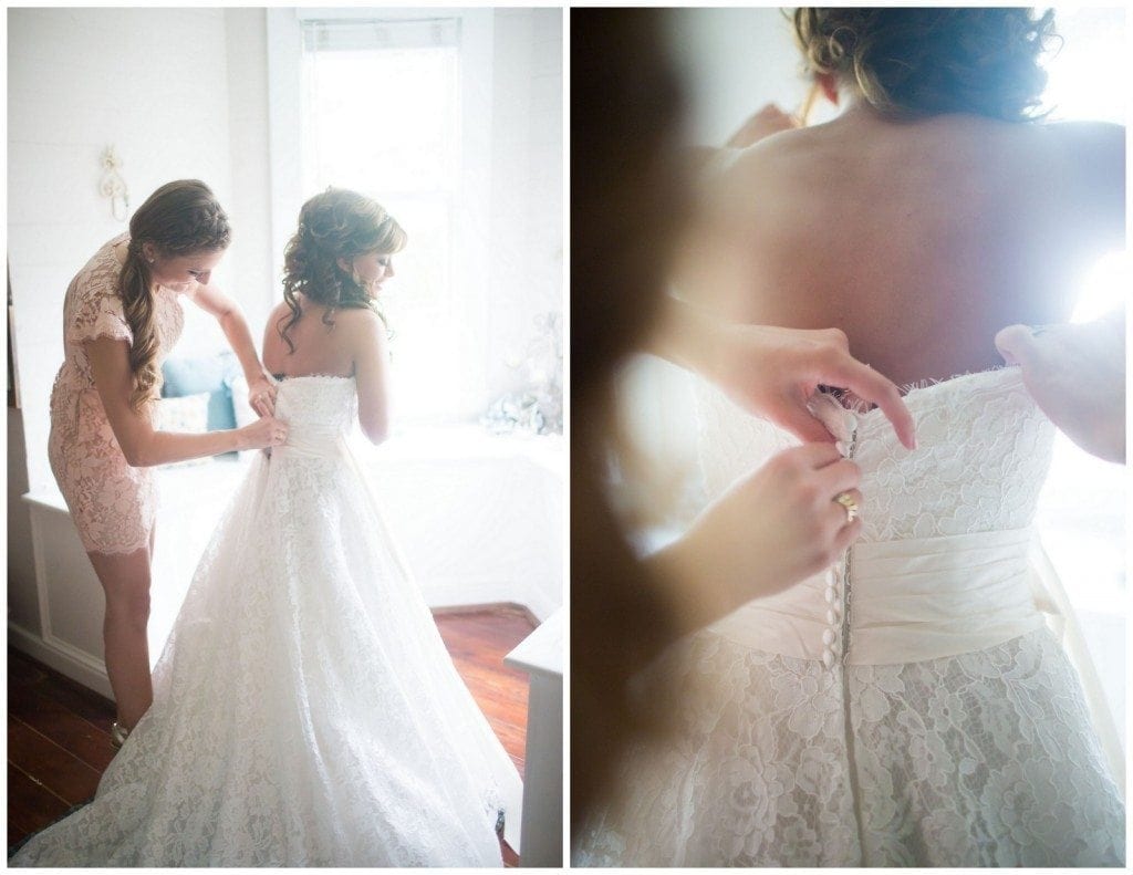 The bride puts on her dress upstairs the home in Oak Tree Manor.  