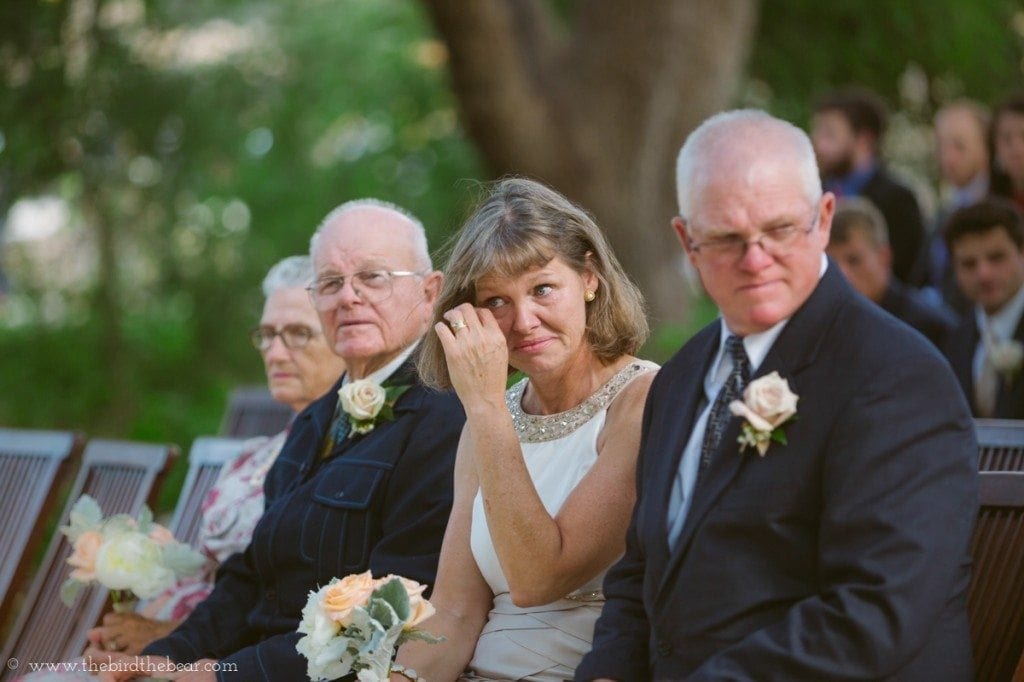 The groom's mother sheds a tear during the wedding ceremony.