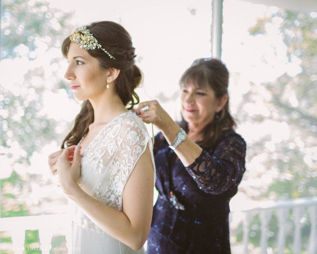 mother of the bride helps bride put her bhldn dress on before her wedding at the winfield inn in kyle tx