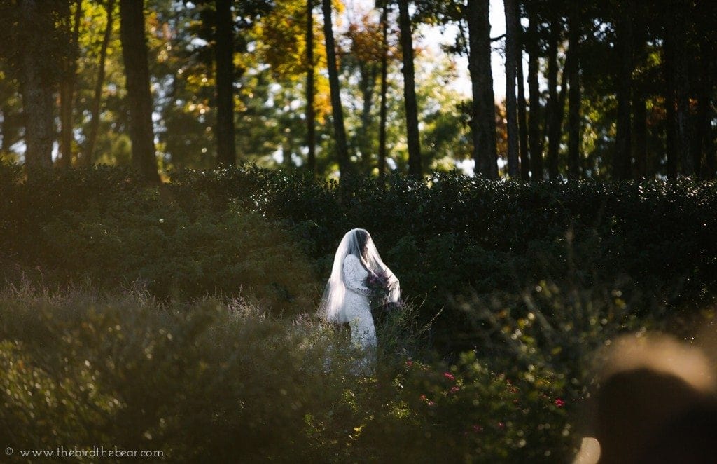 Awesome wedding photo of bride walking down a mountain to her groom during her wedding ceremony