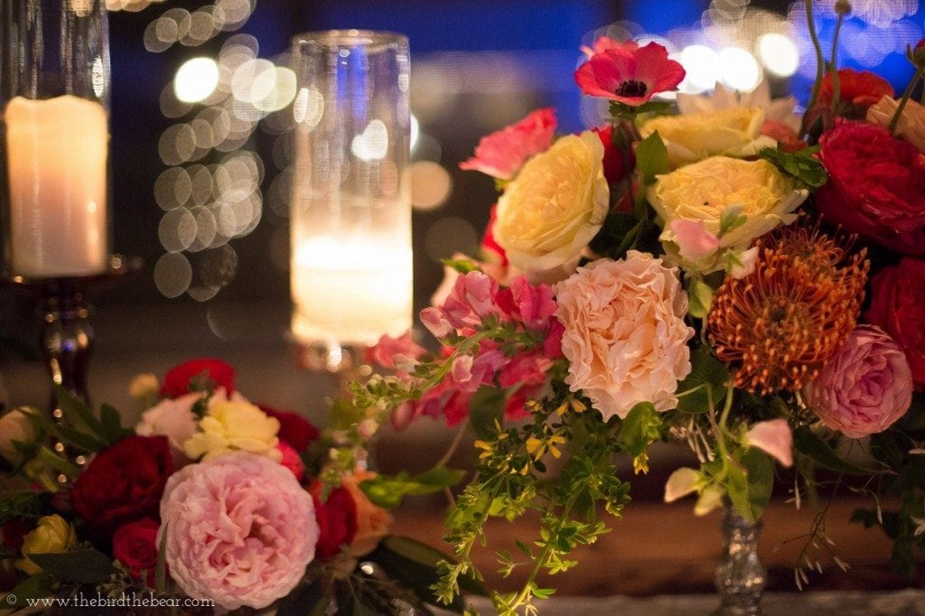 Amazing floral design at an evening wedding with candles and twinkle lights.
