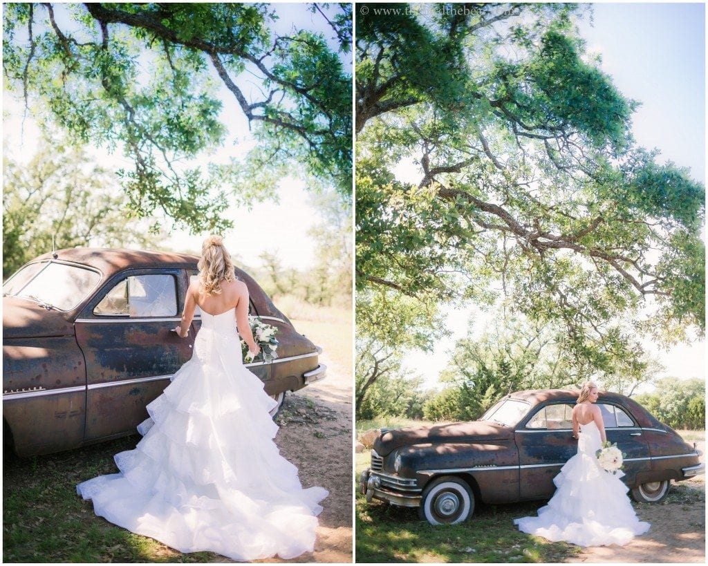 Bride poses in front of the vintage car at Vista West Ranch