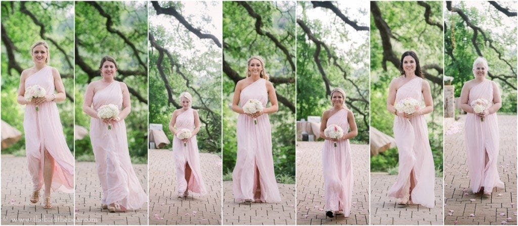The bridesmaids walk down the aisle in their dresses which are light pink with one shoulder strap.  