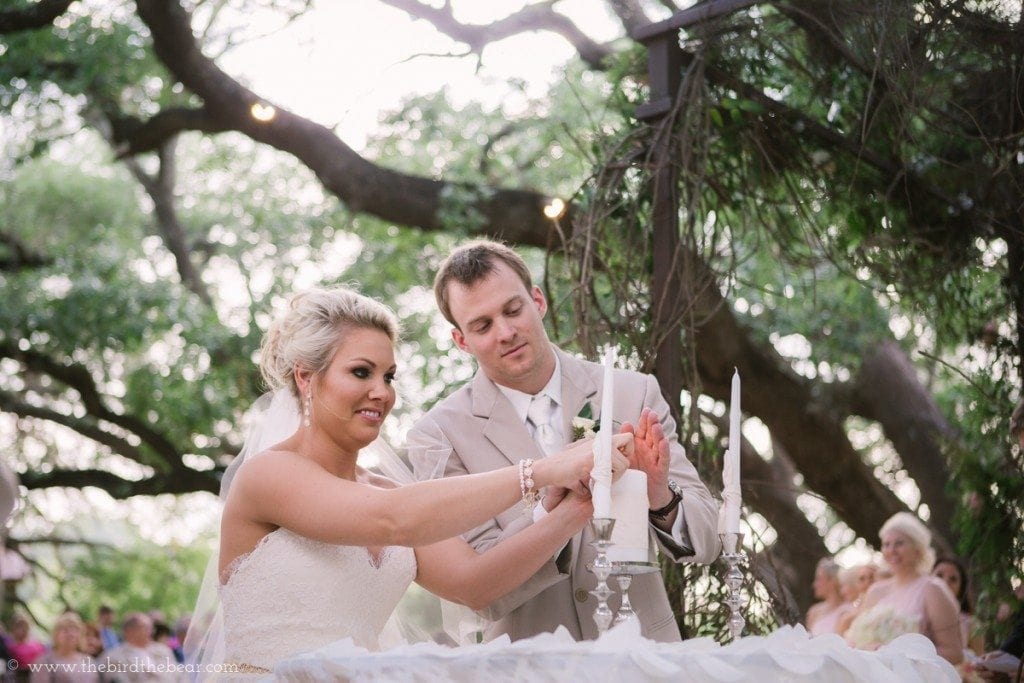 The bride and groom light a unity candle during their wedding ceremony.