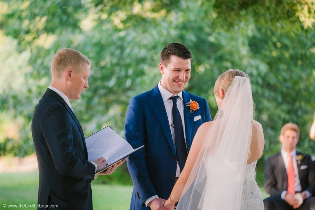 Groom holds hands with bride for the first time at wedding ceremony