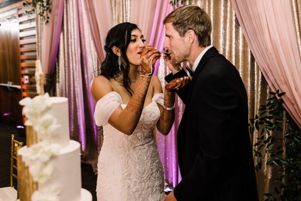 Bride and groom eating cake at their Lakeway Resort wedding