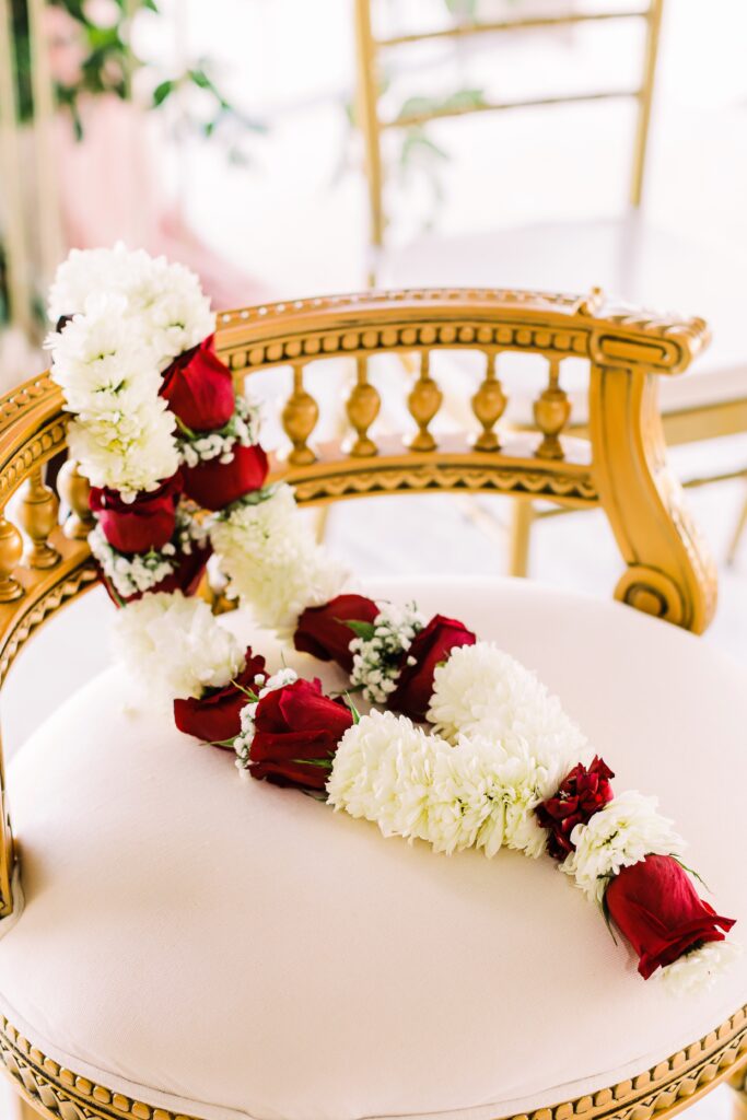 Red and white floral garland at Lakeway Resort wedding ceremony