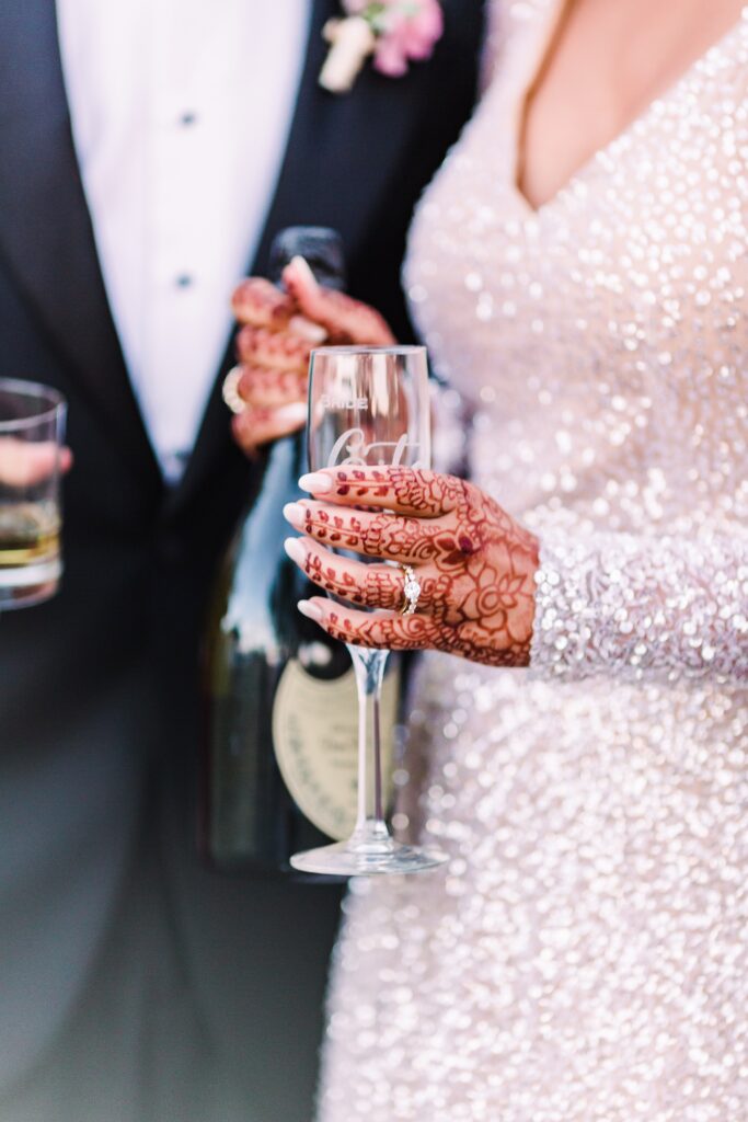 Bride and groom holding champagne glasses at Maes Ridge wedding reception