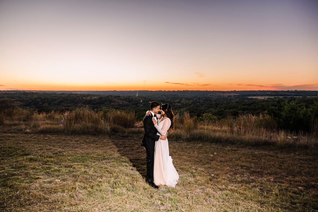 Bride and groom in front of sunset at a Maes Ridge wedding