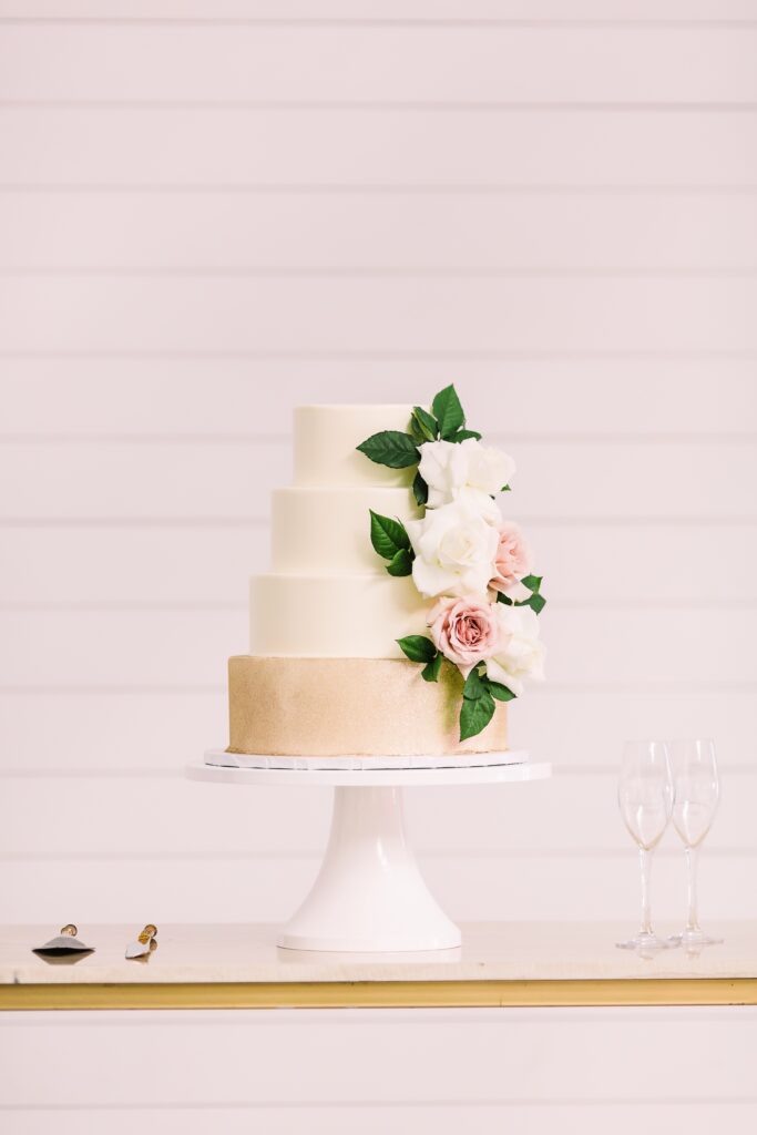 Four tier white and gold wedding cake at Maes Ridge wedding